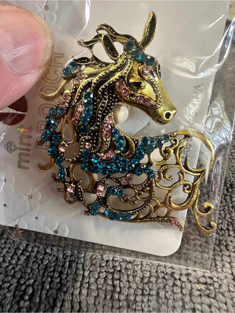 The Horse gold-tone brooch with teal and pink crystals